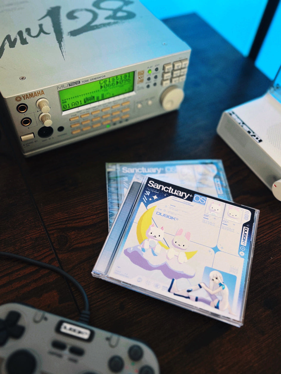 Two Sanctuary OS CDs in jewel case, with CD player, Mu128, and game controller in background