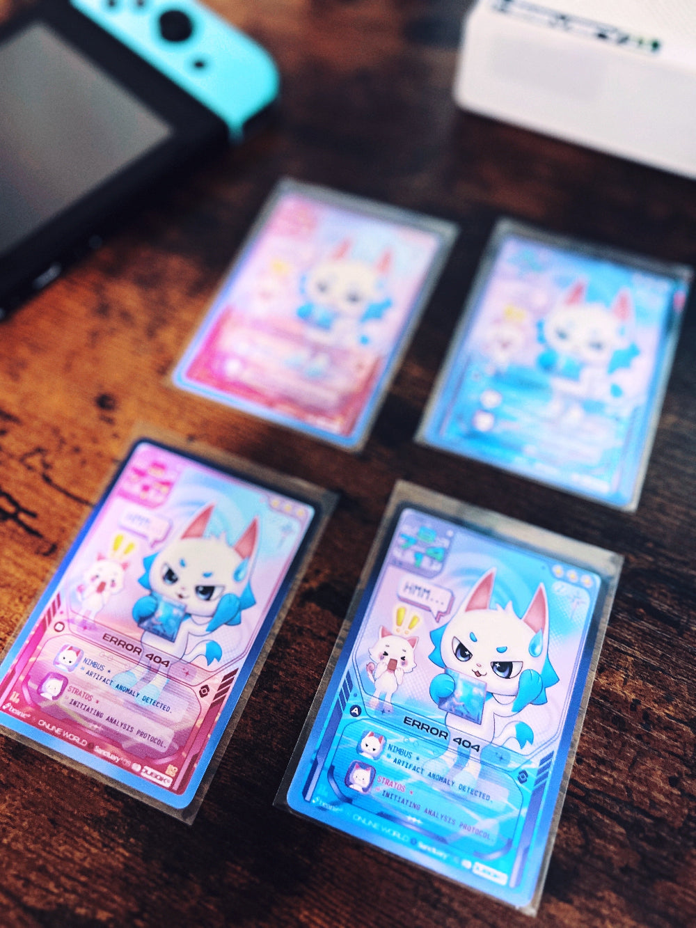 Four "Error 404" trading cards with gaming console and CD player in background